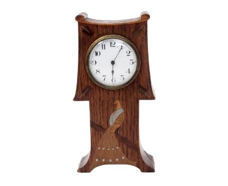 An Arts and Crafts inlaid oak mantel clock,  the shaped wooden body with scroll mantel, inlaid with a peacock in wood and pew