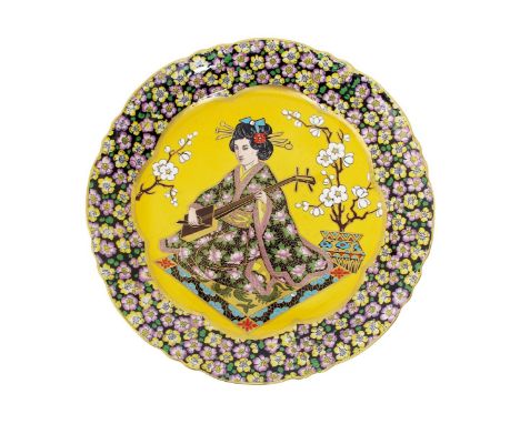 A pottery shallow charger painted with a Geisha playing a musical instrument the design attributed to Lucien Boullemier, poss