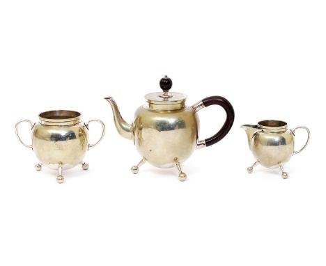 A Hukin & Heath electroplated three piece tea set in the manner of Dr Christopher Dresser, model no.2077, the ovoid body with