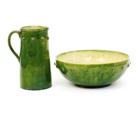 A large Farnham Pottery ewer and basin,  each decorated with a simple band of stud motif, glazed green to the exterior, the i