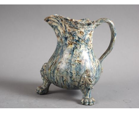 A mid 18th century agate ware cream jug, on lion mask and paw feet, 4" high Condition:  Light crazing to glaze, very small fl