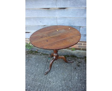 An 18th century oak circular top occasional table, on turned column and tripod splay support, 32" dia x 27" high 