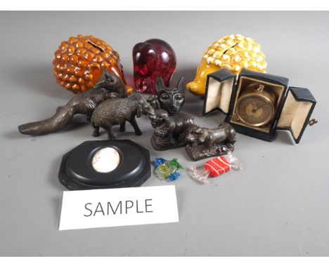 A number of bronzed animal figures, six hedgehog money boxes, glass paperweights, lamp shades and other decorative items 