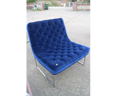 A modern low seat chair, button upholstered in a blue velvet, on chrome frame 