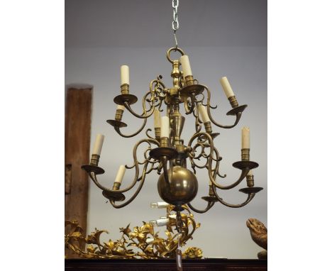 A Dutch style brass two-tier, twelve branch ceiling light, with scrolled arms, 26" wide 