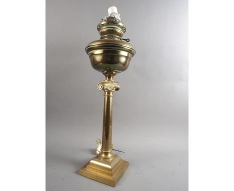 A 19th century brass Ionic column oil lamp with brass reservoir, 23" high (now converted to electricity) 