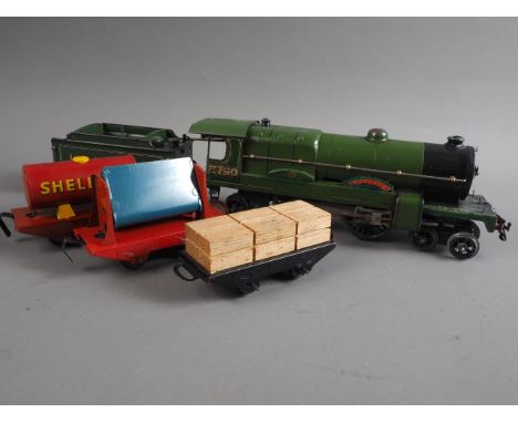 A Hornby O gauge locomotive "2750 Papyrus" with LNER fender, a Shell "BP" oil wagon and two others 