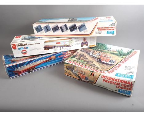 An ERTL blueprint 1/25 scale model kit, International Paystar 5000 Logger, and three similar trailers 