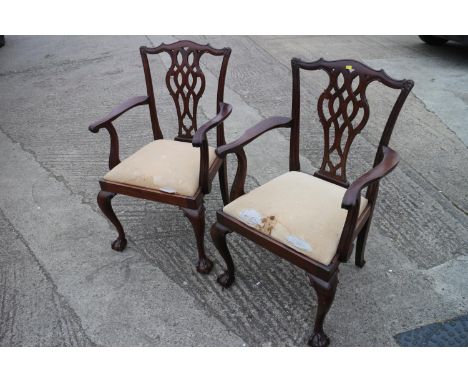 A pair of late 19th century mahogany carver dining chairs of Chippendale design with drop-in seats, on cabriole claw and ball