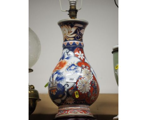 An Imari floral decorated bulbous vase, now a table lamp, on hardwood stand, 26" high 