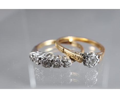 An 18ct gold and platinum five stone illusion set ring, size M, 2.3g, and a similar yellow metal solitaire illusion set ring,