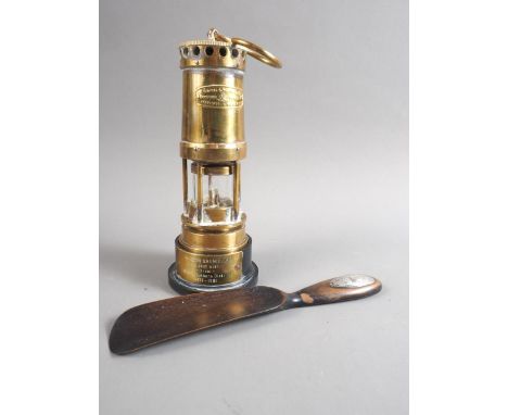 A Thomas and Williams Ltd safety lamp, on presentation stand, and an ebonised shoehorn with silver mount 