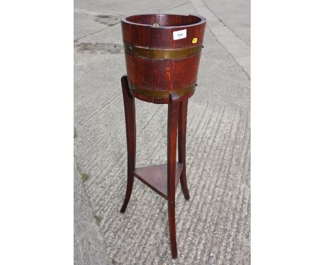 A Railster &amp; Co coopered oak two-tier jardiniere stand, on tripod splay supports, 36 1/4" high 