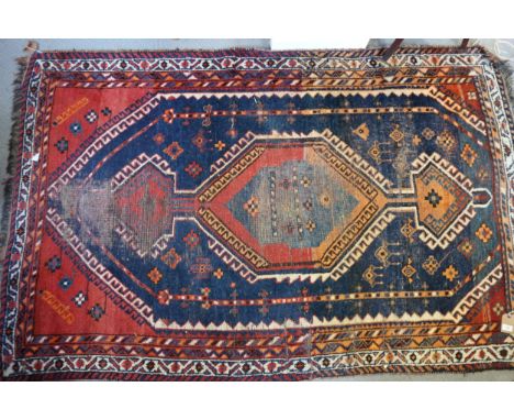 A Caucasian tribal rug in shades of fawn and brown (very worn), 35" x 66" approx, a tribal rug with striped centre ground, 49