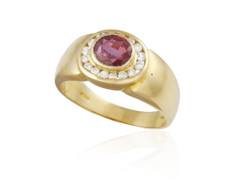 A RUBY AND DIAMOND DRESS RING, the central oval-shaped ruby within collet-setting, to a brilliant-cut diamond frame, mounted 