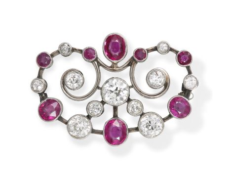 AN EARLY 20TH CENTURY RUBY AND DIAMOND BROOCH, the openwork brooch with scrolling detailing set with old European-cut diamond
