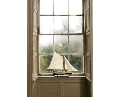 A MODERN TIMBER MODEL OF A SAILING BOAT, on a rectangular platform base. c.80cm high x 92cm long overall