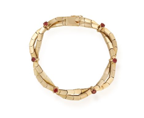 A RUBY BRACELET, composed of two rows of intertwined fancy-links, highlighted with circular-cut rubies, mounted in 18K gold, 