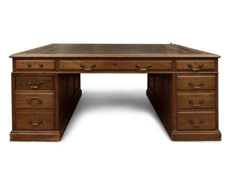 A 19TH CENTURY MAHOGANY AND LEATHER INSET PARTNER'S DESK, the rectangular top with gilt tooled decoration, fitted to either s