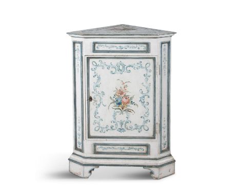 AN ITALIAN WHITE PAINTED TIMBER CORNER CUPBOARD, hand-painted with washed blue scrollwork and central floral posey, with moul