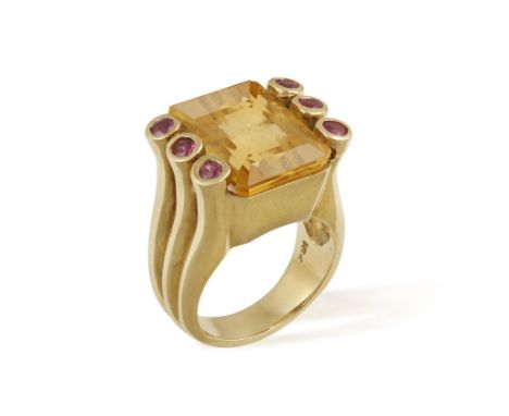 A CITRINE AND RUBY COCKTAIL RING, the large rectangular-cut citrine between circular-cut ruby shoulders, mounted in 18K gold,