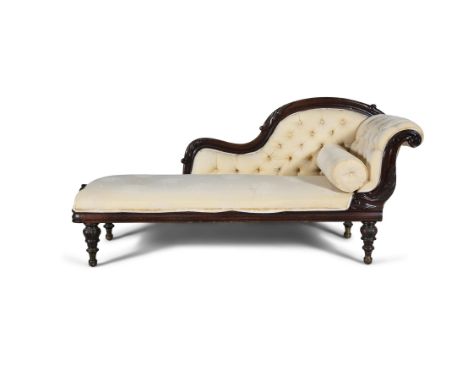 A VICTORIAN MAHOGANY CHAISE LONGUE, covered in a button back yellow damask, on leaf carved turned legs. 192cm wideCondition R