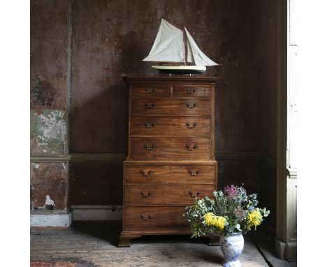 A GEORGE III MAHOGANY CHEST ON CHEST, C.1800, with dentil cornice and angled corners, fitted with two short and six long grad