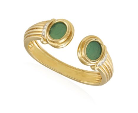 A DIAMOND AND GOLD BANGLE, the reeded bangle with green intaglio terminals (possibly green agate) highlighted with brilliant-
