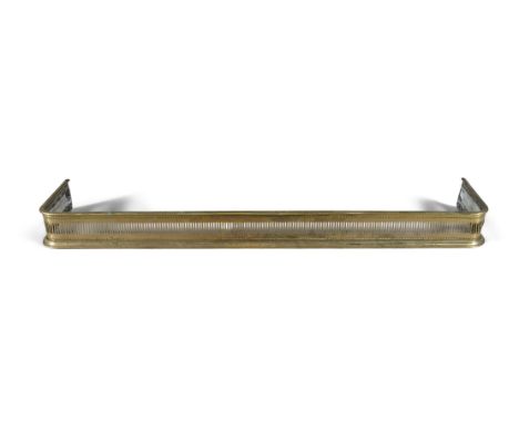 A GEORGE IV BRASS FENDER, with pierced gallery. 158cm wide