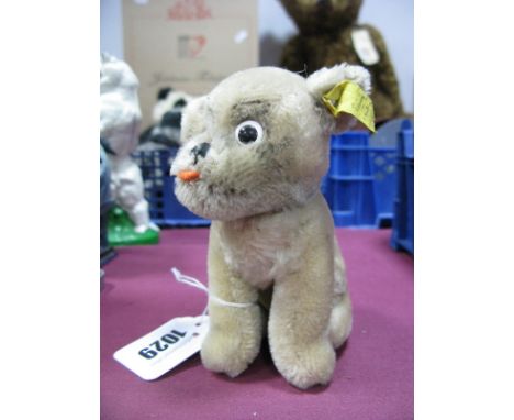 A 1960's Vintage Steiff Dog Mopsy, seated, in beige plush with swivel head, button and label to ear, 12cm high.