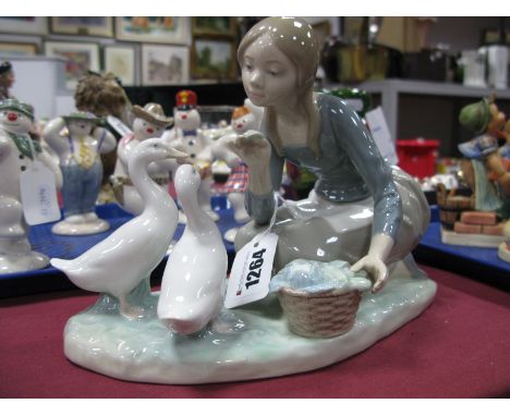 A Lladro Model 'Girl Feeding Geese Cabbage'.
