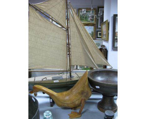 A Four Sail Model Boat on Stand; together with a wooden bowl and wooden duck.