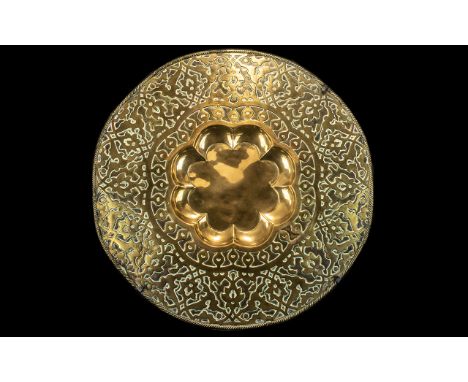 Large Brass Middle Eastern Antique Table Top, finely embossed with an Islamic floral design, the centre recessed with a petal