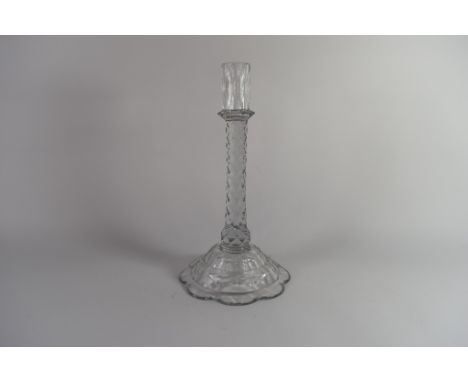 Late 18th/early 19th century facet cut taper stick with slender nozzle above an octagonal mount, the faceted stem above a dom