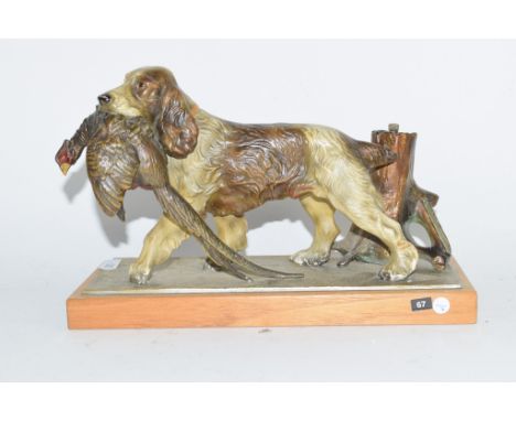 Cold cast painted table lighter depicting a spaniel carrying a pheasant in its mouth, on wooden base, base length approx 25cm