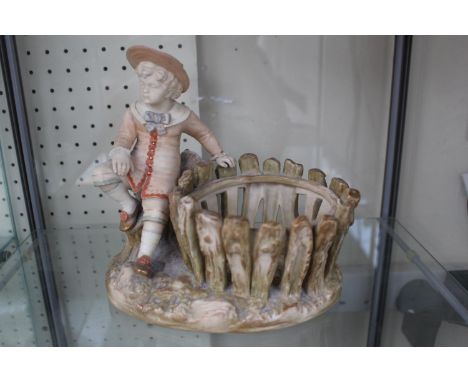 A Royal Worcester basket modelled as a young boy in sailor style costume seated beside a rustic. Pattern 1231 Rd No 75405. 17