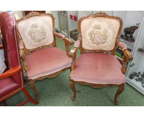 Pair of upholstered Louis style carved Elbow chairs with tapestry backs and scroll feet 