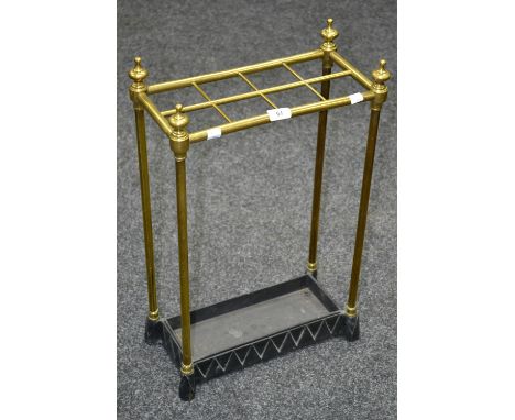 A brass and cast iron stick stand, turned finials, circa 1900