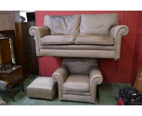 A modern three piece suite comprising of a two seat sofa,a chair and a pouffe