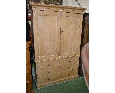 A Victorian stripped pine linen press, ogee cornice, two fielded panel doors enclosing shelving and coat hooks to top, two sh