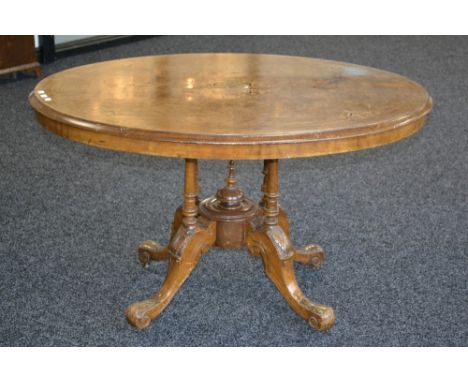 A Victorian burr walnut quarter veneered loo table, inlaid throughout, carved base, ceramic casters, c.1860