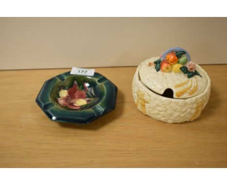 A Moorcroft Freesia ashtray sold alongside a Clarice Cliff preserve jar.