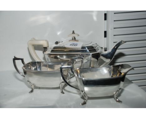 An early 20th century three piece Art Deco EPNS tea service comprising tea pot with white composite handle plus milk jug and 