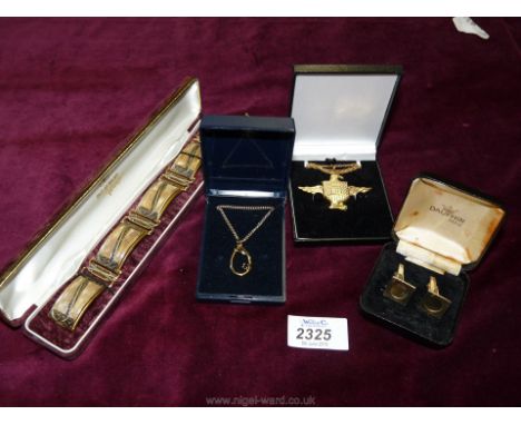 An Eagle pendant and chain, a gold coloured pendant and chain, a pair of Dolphin cufflinks and a large gold coloured bracelet