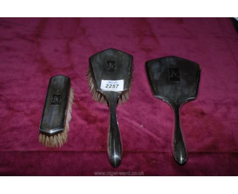 A three piece silver dressing table set in Art Deco style with engine turned design dated 1946/47 by William Adams.