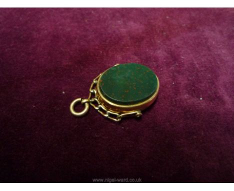A 9ct. gold framed, chain style support rotating oval Fob having contrasting dark grey and ochre coloured polished stones to 