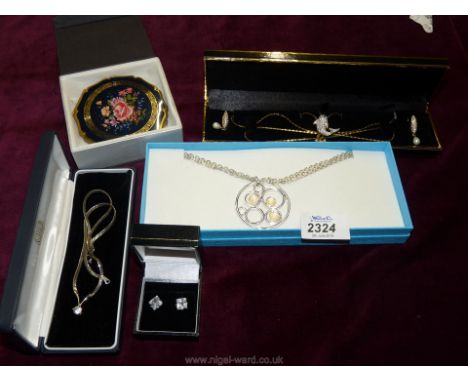A Rose Stratton compact, large silver coloured pendant and chain, a pretty necklace and pendant with Pearl earrings, silver c