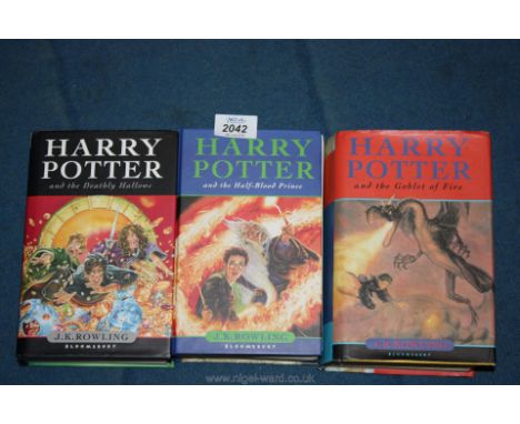 Three First Edition Harry Potter novels.