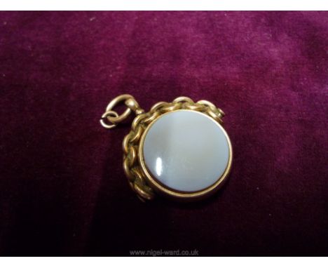 A 9ct. gold framed, chain style support rotating circular Fob having contrasting moonstone and dark stone to the faces.  Make