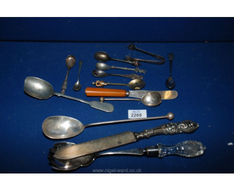Miscellaneous cutlery including salad serving spoon, bread knife, miscellaneous collectors spoons, serving spoons.